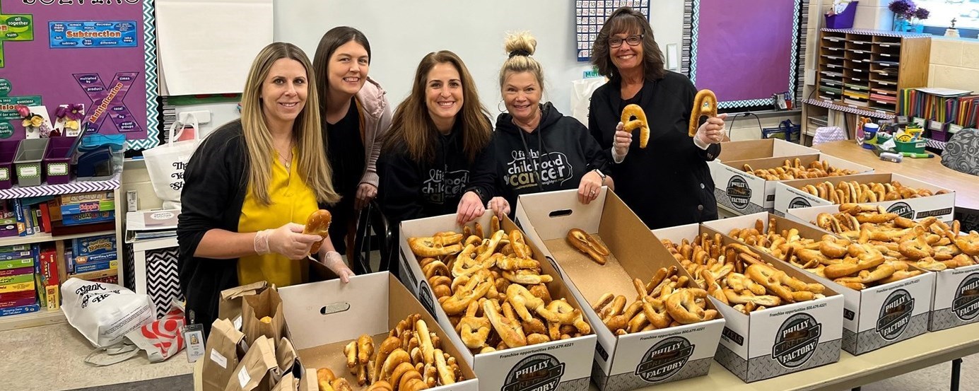 Staff members counting out pretzels for fundraiser for Aaron