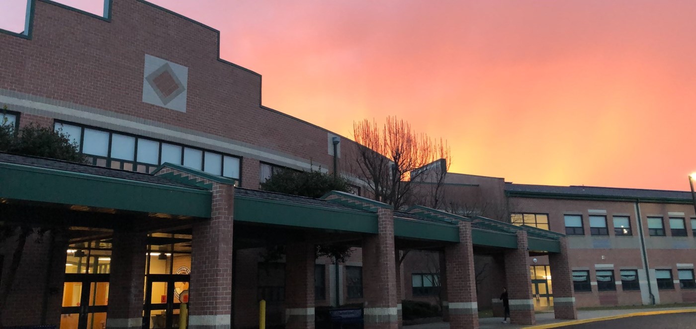 Photo of Hartford School in the morning with a pink sky