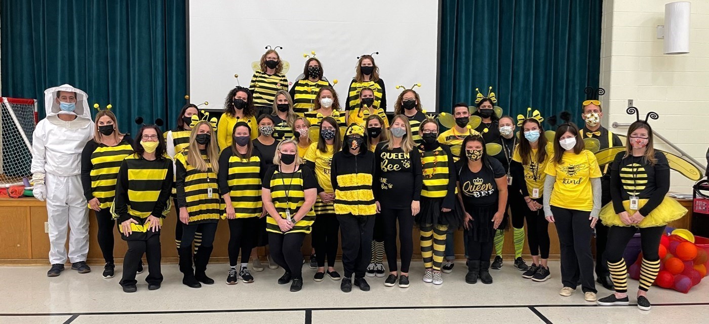 Halloween staff members dressed as bees and a bee keeper