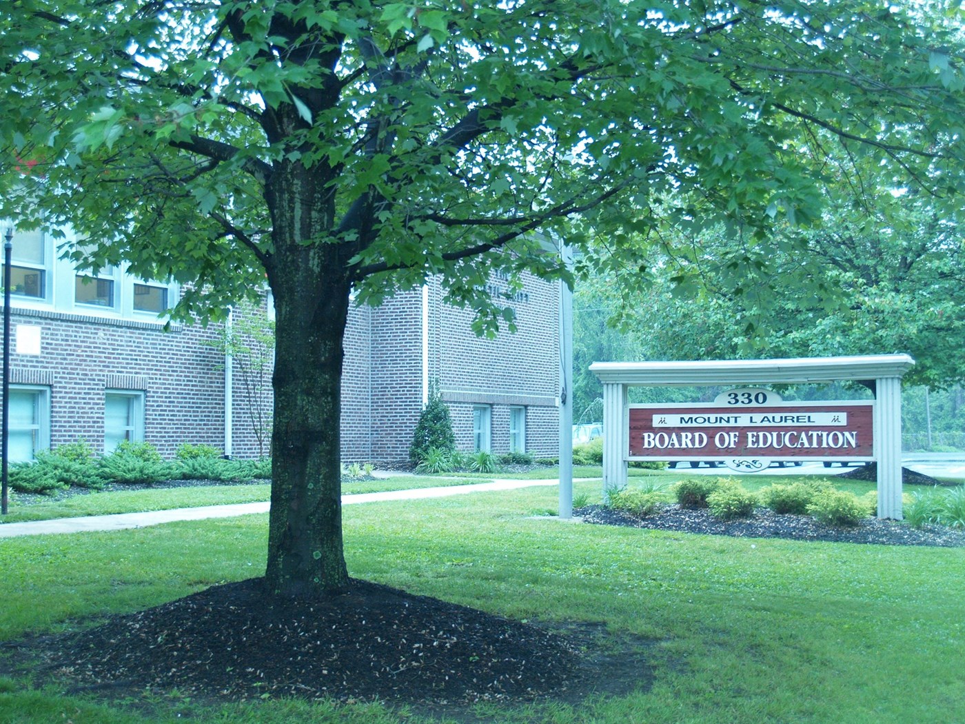 330 Mount Laurel Board of education Sign - Image of District building, sign and garden with oak tree in centre of mage