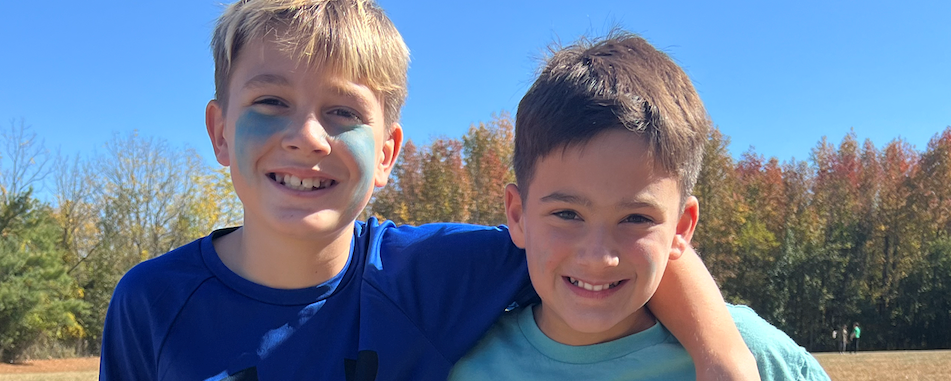 Two Students in Blue on Field Day