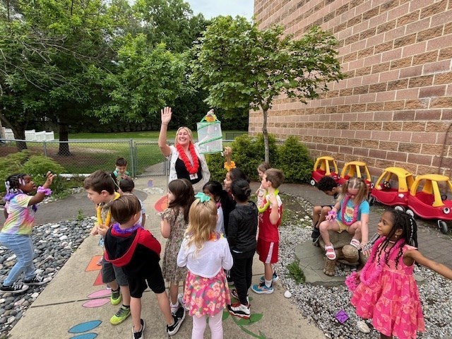 Kindergarten students releasing butterflies