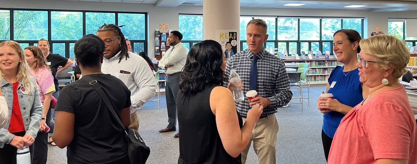 Parents and administrators talking at HHSPTO Welcome