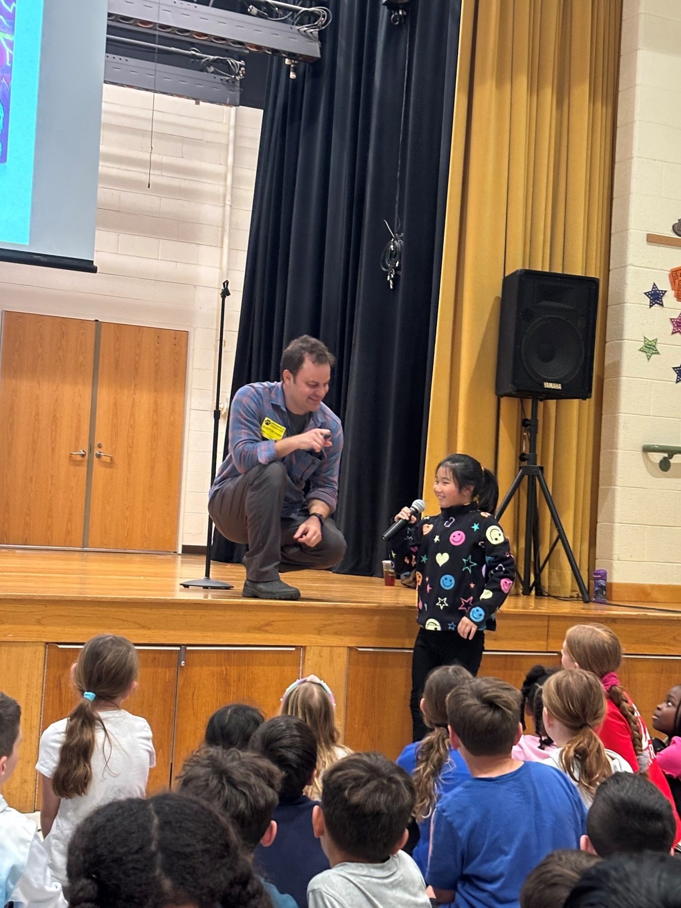 Author, Jason Patterson, speaking with a 3rd grade student during his visit