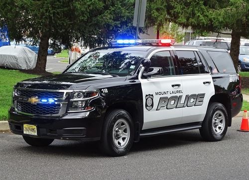 Image of Mount Laurel Police Vehicle parked in street with lights flashing